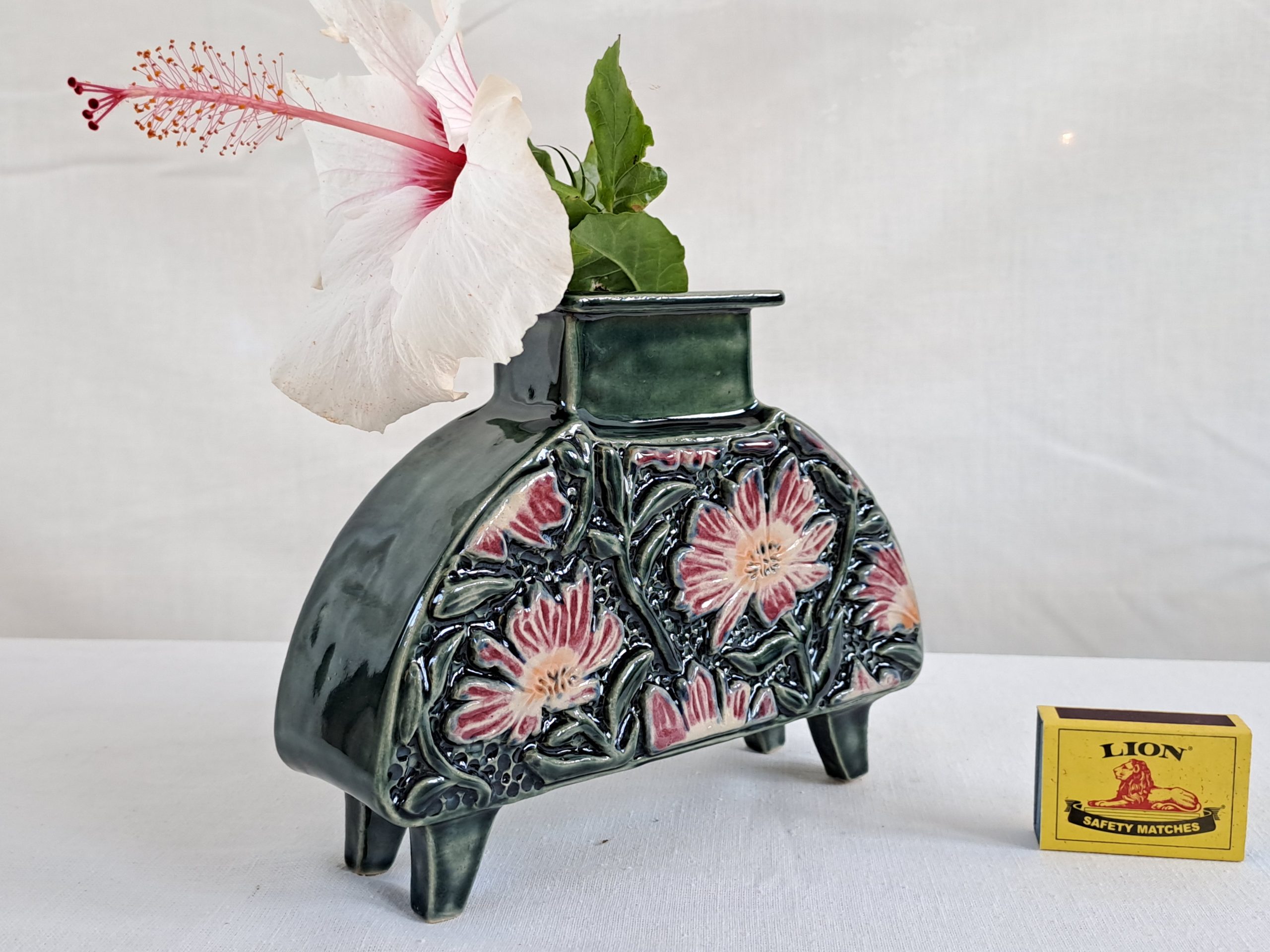 Decorative daisy floral pink and dark slate green handmade ceramic vase with hibiscus flower.