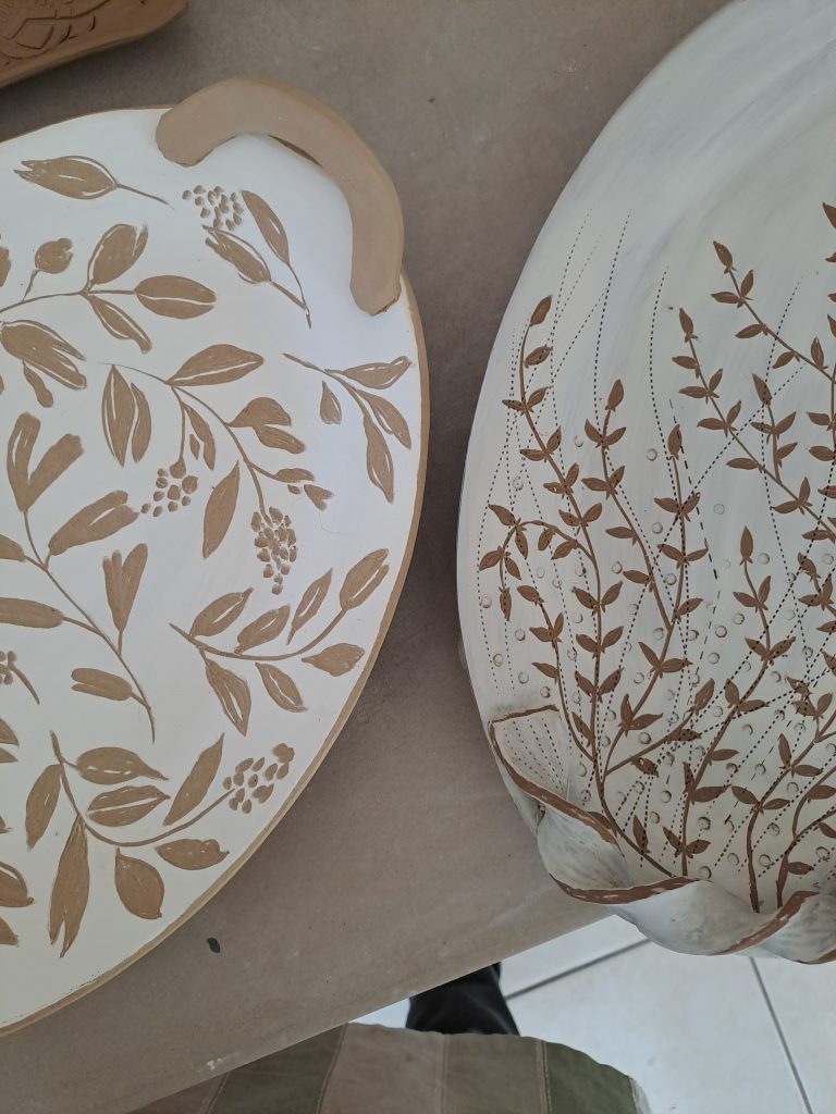 Two beige and white floral decorative serving trays created by Jo Ceramics
