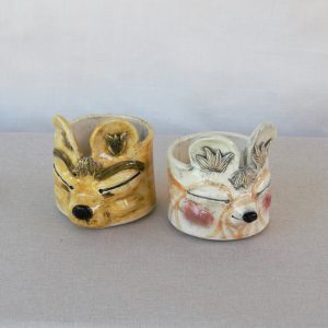Little creatures with closed eyes. Made by Jo Ceramics