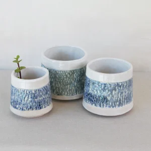 Three small handcrafted ceramic planters with a smooth white glaze and a textured, variegated blue-green band around the middle, blending rustic artistry with a modern aesthetic. Made by Jo Ceramics
